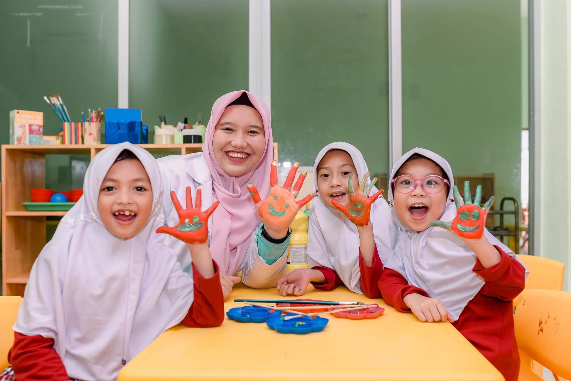 Guru dan murid Prestige menunjukkan telapak tangan penuh cat warna-warni